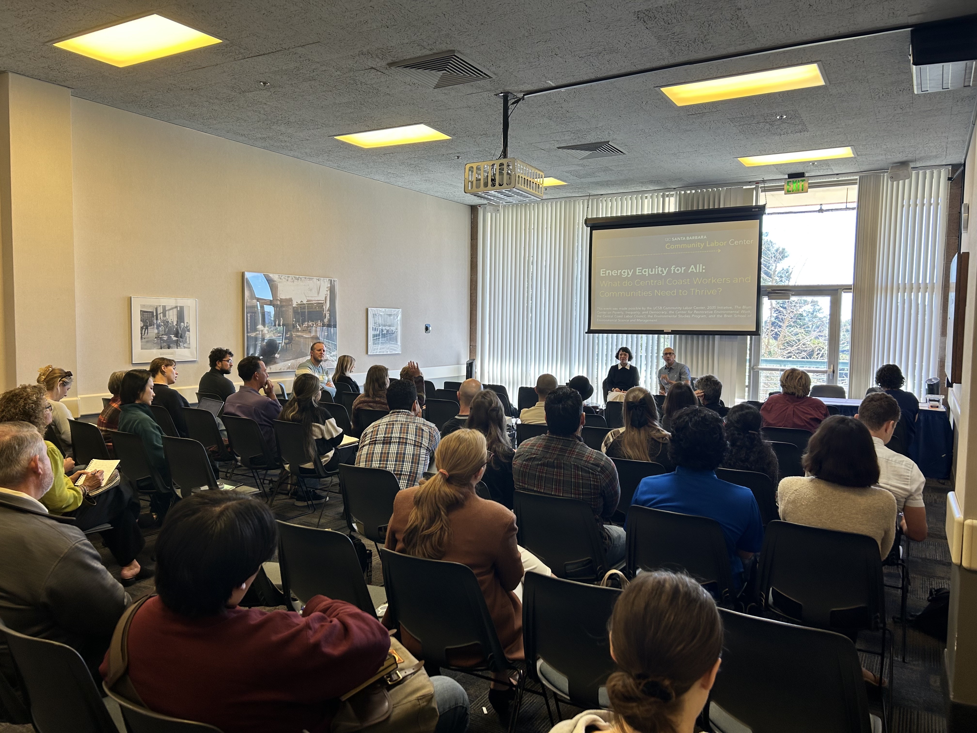 Photo of J. Mijin Cha campus visit, with a room full of people watching her speak